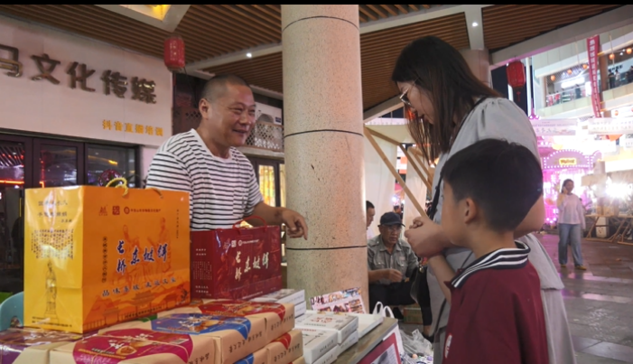 游客在摊位前咨询购买郏县特色产品.png