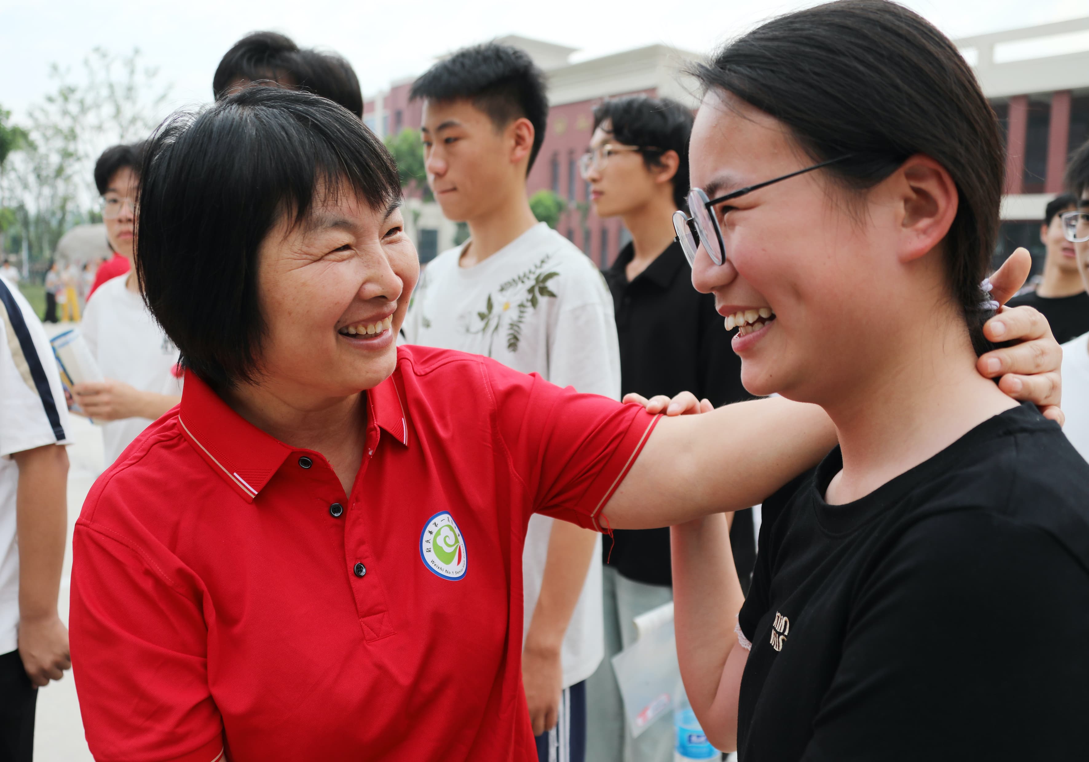 6月7日，尉氏县第一高级中学考点门前，老师身着红衣寓意“开门红”，给考生加油鼓劲，暖心送考。 (2).jpg
